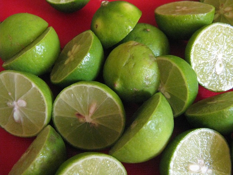 Green limes cut in half. Seeds are present.