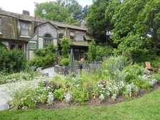 Border with white & blue flowers, and 2 lattice obelisks.