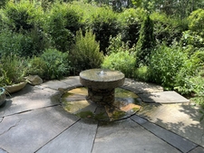 Small fountain made from a millstone.