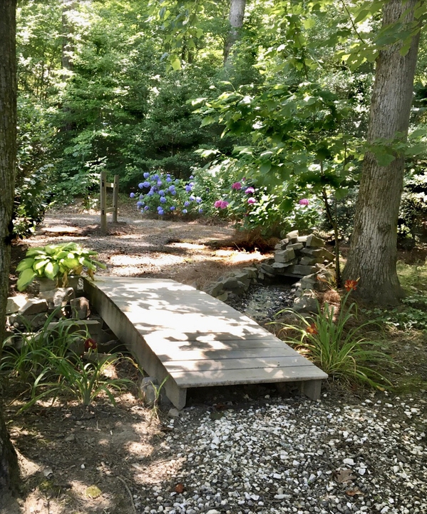 A rustic footbridge over a stream.