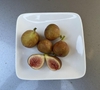 Plate of figs; one cut in half to show pink interior.