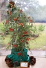 Small tree in a pot decorated for Christmas