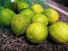 Green limes with yellowish blotches on the skin