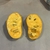 Cut fruit showing creamy orange flesh and large seeds.