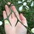 Hand cradling branch with large thorns and flowers