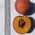Two peaches: one whole & one-half fruit sitting on a clipboard.