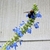 Spike of blue flowers with large bee.