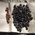 Gathered piles of dark purple-black drupes and brown seeds