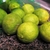 Green limes with yellowish blotches on the skin