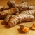 Rhizomes on a table; one is cut to show orange interior.